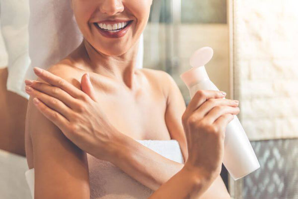 Women in towel with body cream